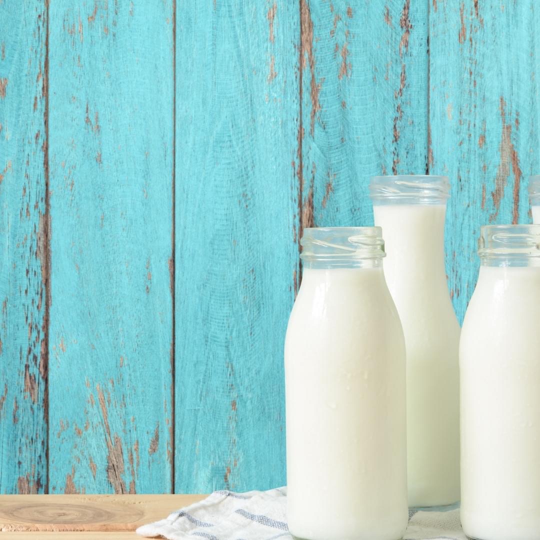 A bottle of milk alongside dairy-free alternatives such as almond, oat and coconut